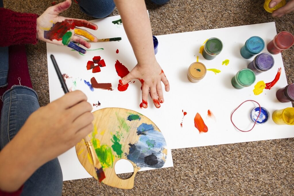 Development of motor skills in children: games that develop hand motor skills High-angle-child-woman-painting