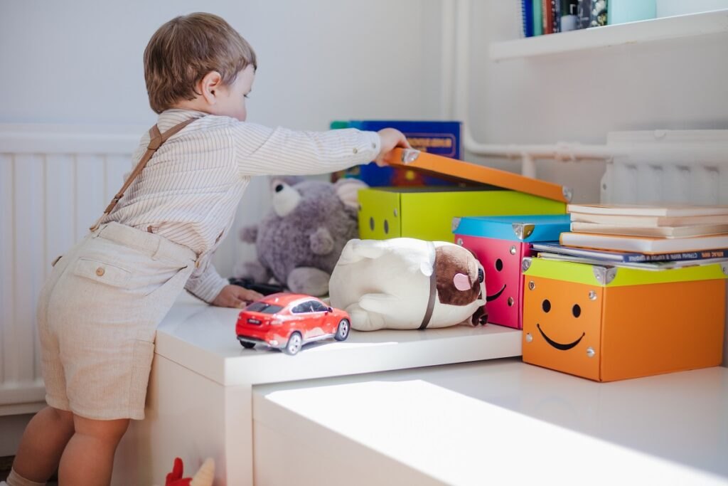 Development of motor skills in children: games that develop hand motor skills Little-boy-opening-box-with-toys